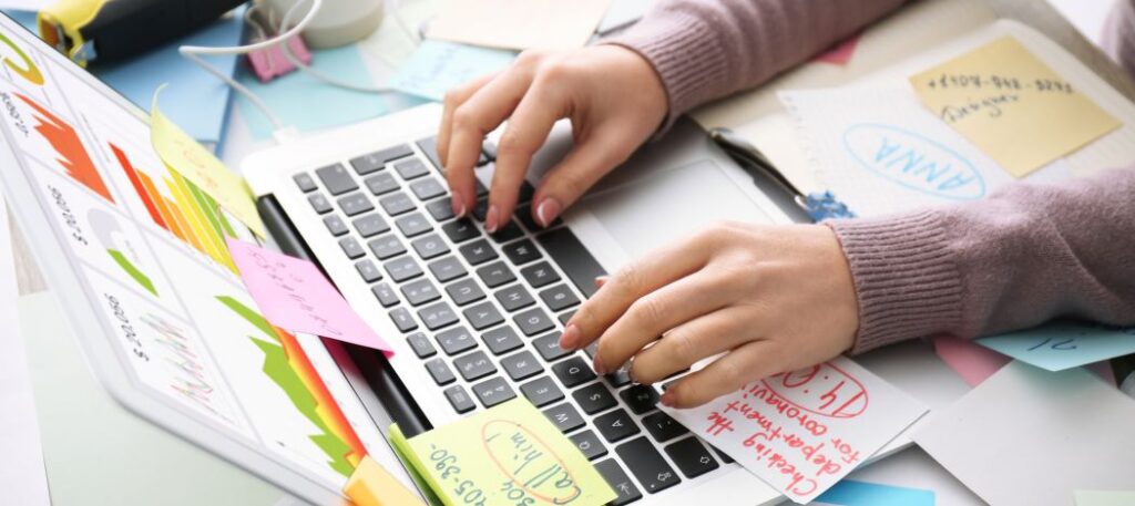 Computer keyboard with post it notes on it