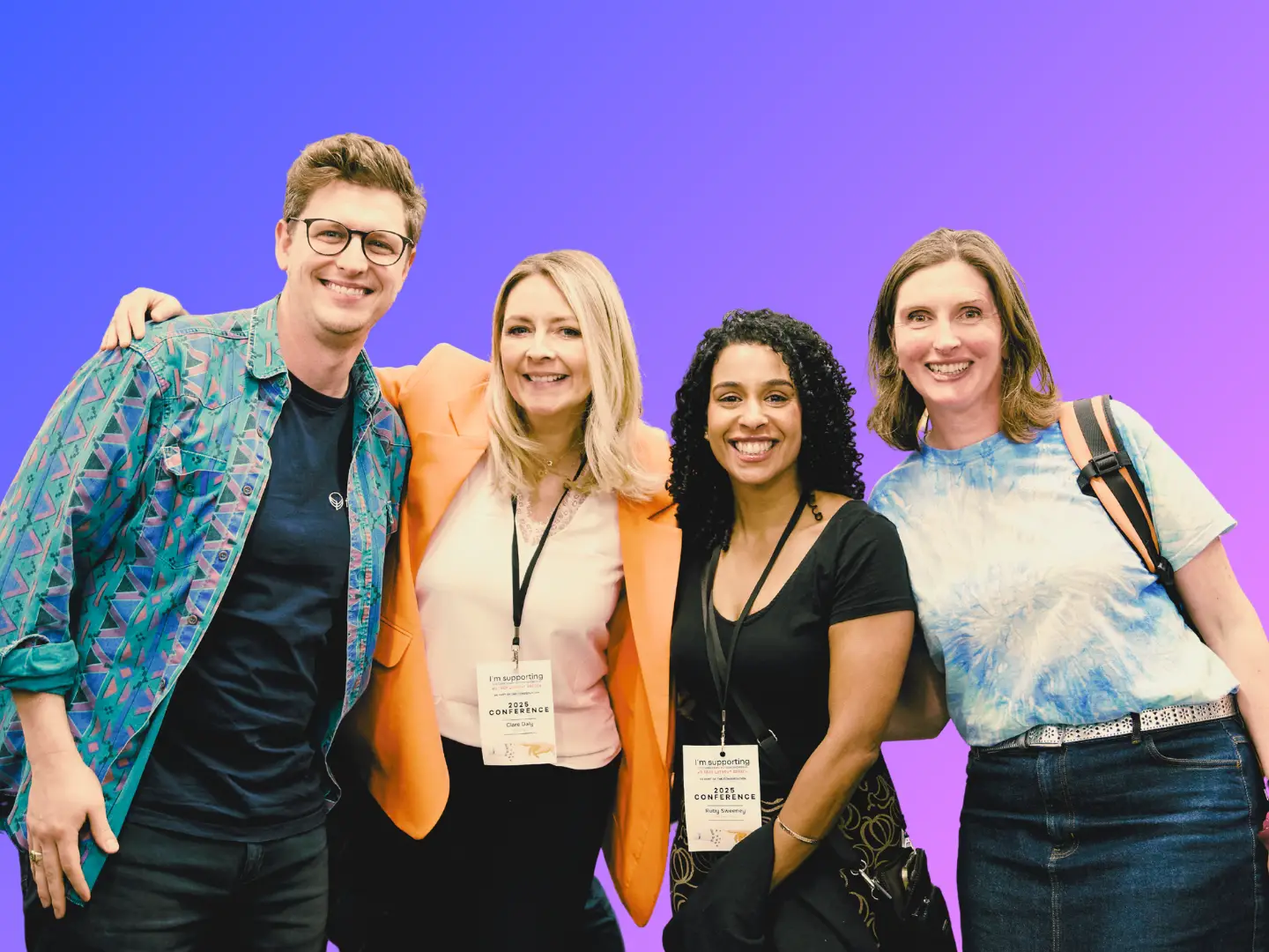 4 people with arms around each other smiling.